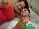 man and woman on floor eating pitza happy 1024x768