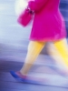 woman walking fast portrait format