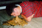 man vomiting on floor
