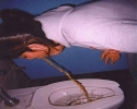 woman vomiting into toilet bowl