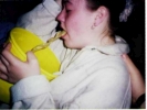 woman vomiting into a yellow bowl 1024x768