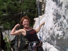 confident woman climbing cliff face 800x600
