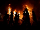 riot police marching from side with flames behind 1024x768