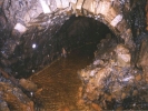 caving tunnel stone arch