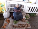 market woman selling vegatables from floor of market p1020020 b