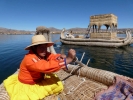 people tribal girl steering reed boat on lake p1000839 b