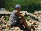 war woman in rubble of house 2
